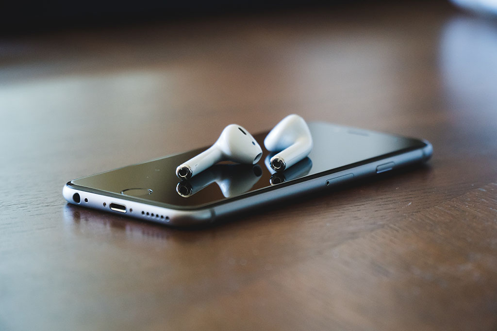 Mobile phone and ear phones have been left on the desk to eliminate distractions while reading. 