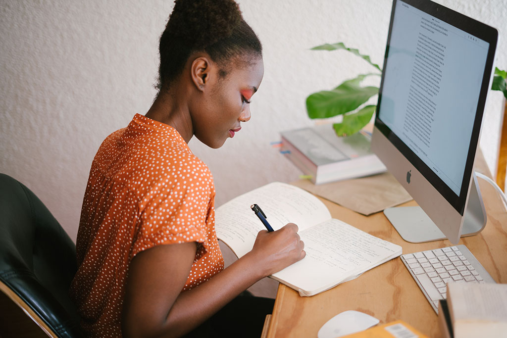 Focused woman taking notes after speed reading.